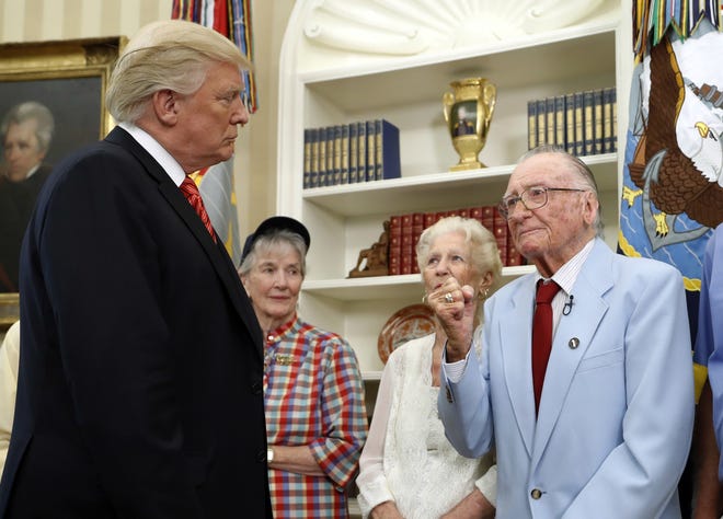 President Donald Trump listens to USS Arizona survivor Donald Stratton, right, during a meeting with survivors of the attack on USS Arizona at Pearl Harbor, in the Oval Office of the White House, Friday, July 21, 2017, in Washington. (AP Photo/Alex Brandon)