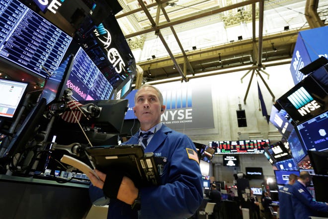 Trader Timothy Nick works on the floor Wednesday at the New York Stock Exchange. U.S. stocks held steady in morning trading, following sharp drops for markets around the world. [AP PHOTO / RICHARD DREW]