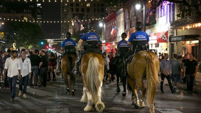 Austin mounted police officers patrol Sixth Street in June. JAY JANNER / AMERICAN-STATESMAN