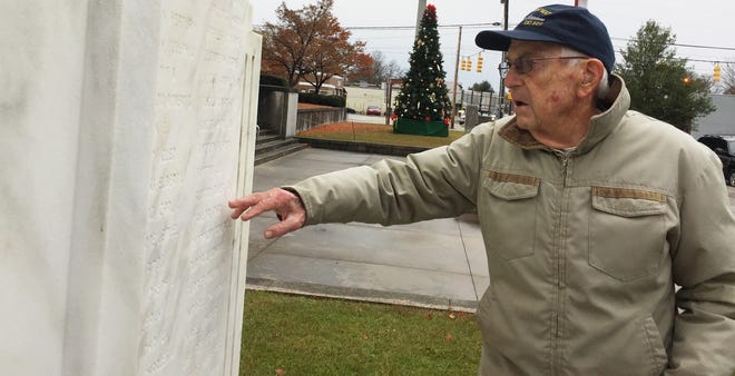 Jerry Kanter, a WWII veteran, searches the Lenoir County World War II monument for friends, classmates and fellow service members after a memorial ceremony honoring those killed at Pearl Harbor. [Dustin George/ The Free Press]