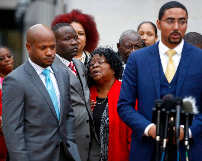 FILE - In this Monday, Dec. 5, 2016, file photo, Judy Scott, center, Walter Scott’s mother, is comforted by her son Rodney Scott, as the family attorneys, Chris Stewart, left, and Justin Bamberg, right, hold a press conference after a mistrial was declared in former South Carolina officer, Michael Slager’s trial in Charleston, S.C. Slager, who fatally shot a black motorist, Walter Scott, in 2015, could learn his fate as soon as his federal sentencing hearing winds down. On Thursday, Dec. 7, 2017, attorneys are expected to call friends and relatives of both men who’ll tell the judge how Scott’s death and the officer’s arrest have impacted their lives. (AP Photo/Mic Smith, File)