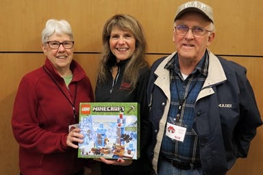 SIS Bank’s Linda Nadeau (middle) stands with Bob (right) and Louise Lantagne (left) of Santa’s Cause Maine with this year’s community scavenger hunt gift. For 13 years, Santa’s Cause Maine has been helping bring “Christmas Magic” to York County children in need.

[Courtesy photo]