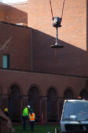 One of Ai Weiwei’s sculptures is moved into position in the north courtyard at the Jordan Schnitzer Museum of Art on the campus of the University of Oregon on Nov. 29. (Brian Davies/The Register-Guard)