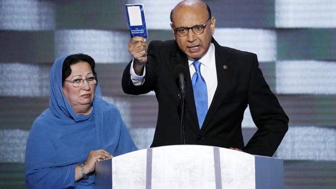 Khizr Khan, father of fallen US Army Capt. Humayun S. M. Khan, speaks as his wife, Ghazala, listens during the final day of the Democratic National Convention in Philadelphia in 2016.