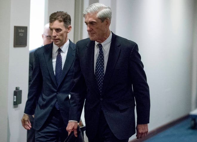 In this June 21, 2017, file photo, former FBI Director Robert Mueller, the special counsel probing Russian interference in the 2016 election, departs Capitol Hill following a closed door meeting in Washington. Mueller has produced hundreds of thousands of documents, copies of data from 36 electronic devices and gathered 2,000 “hot” documents in the government’s case against Paul Manafort and Rick Gates. Mueller’s investigators made copies of information on cell phones and hard drives and disclosed the existence of 15 search warrants and other requests in their investigation of Trump’s former campaign chairman and his deputy, according to a new court filing made Friday. (AP Photo/Andrew Harnik, File)