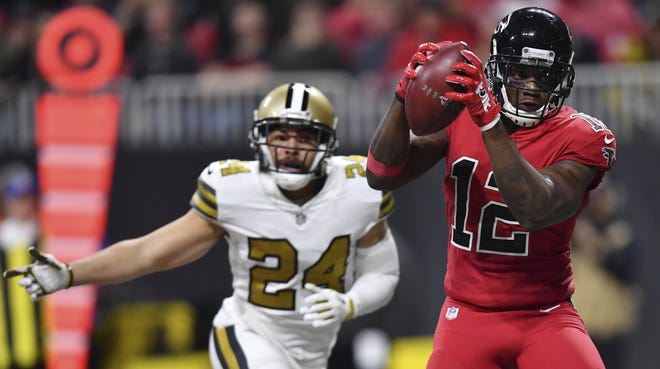 Atlanta Falcons wide receiver Mohamed Sanu (12) makes a touchdown catch against New Orleans Saints cornerback Sterling Moore (24) during the second half of a game Thursday in Atlanta. [AP Photo / Danny Karnik]