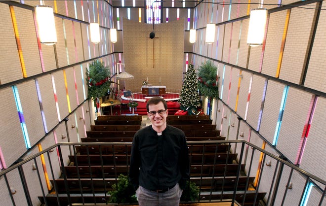 Pastor Micah Kearney inside the Lutheran Church of the Holy Comforter in Belmont which turns 100 years old this year. [JOHN CLARK/THE GASTON GAZETTE]