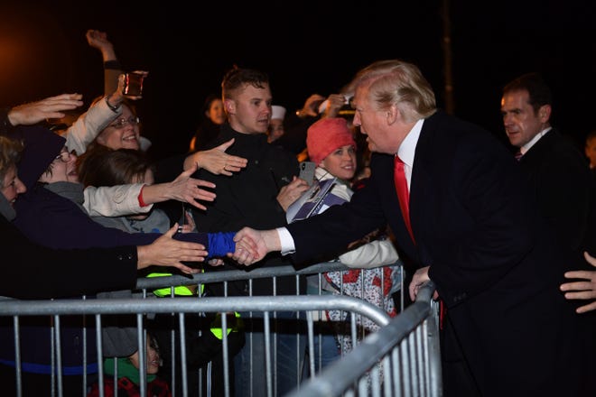 President Donald Trump greets people after he arrived Friday on Air Force One at Naval Air Station Pensacola in Pensacola. [SUSAN WALSH/AP]