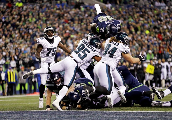 (File) The Seahawks' Mike Davis (39) leaps into the air but is stopped short of the goal line by the Eagles' defense during Sunday's loss in Seattle. [Ted S. Warren/Associated Press]