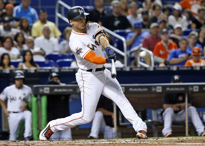Miami Marlins' Giancarlo Stanton hits a home run during a game against the Chicago Cubs on June 23 in Miami. A person familiar with the negotiations says the New York Yankees and Miami Marlins have agreed on a trade that would send Stanton to New York. [AP Photo / Wilfredo Lee, File]