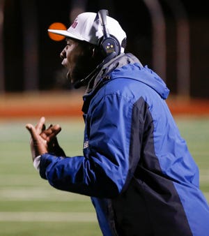 John Marshall coach Rashaun Woods yells instructions to his team in the fourth quarter during the Class 3A championship Friday. John Marshall won 14-7. [Photo by Nate Billings, The Oklahoman]