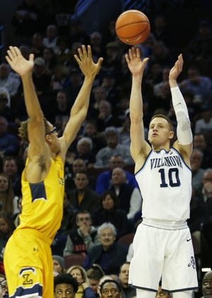 Villanova guard Donte DiVincenzo (10) takes a three point shot over La Salle center Miles Brookins Sunday in Philadelphia. [LAURENCE KESTERSON / THE ASSOCIATED PRESS]