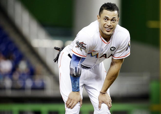 In this Aug. 14 file photo, Miami Marlins' Giancarlo Stanton stands on the field during a baseball game against the San Francisco Giants in Miami. The New York Yankees and Miami Marlins have agreed on a trade that would send slugger Giancarlo Stanton to New York and infielder Starlin Castro to Miami. [LYNNE SLADKY/ASSOCIATED PRESS]