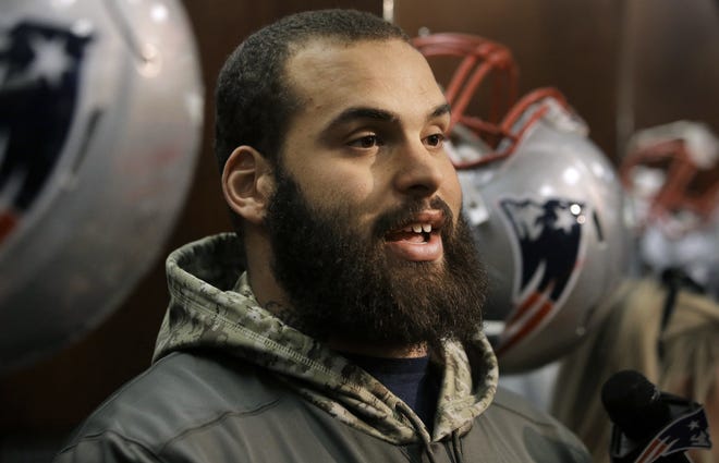 New England Patriots defensive end Lawrence Guy takes questions from reporters following a recent practice in Foxborough, Mass. Guy has overcome multiple learning disabilities to become a productive NFL player. [Photo by AP]