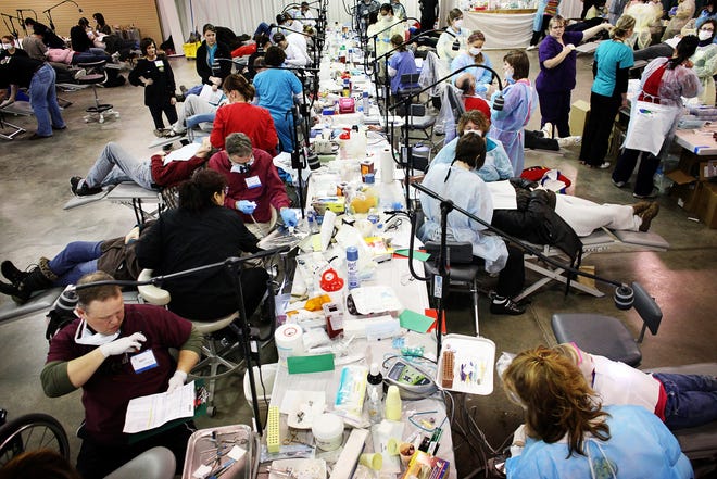 Over 900 volunteers comprised of dentists, dental hygienists, assistants, and general labor donated their time and services to benefit people in need of dental care attending the Mission Of Mercy dental clinic on Friday, January 21, 2011, at the Kansas State Fairgrounds in Hutchinson. [File photo/HutchNews]