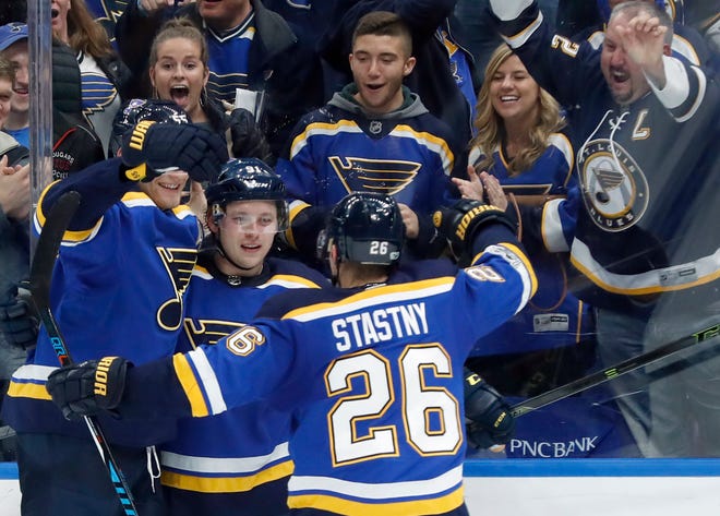St. Louis Blues' Vladimir Tarasenko, of Russia, is congratulated by teammates Colton Parayko, left, and Paul Stastny (26) after scoring the game-winning goal during overtime of an NHL hockey game against the Buffalo Sabres, Sunday, Dec. 10, 2017, in St. Louis. (AP Photo/Jeff Roberson)