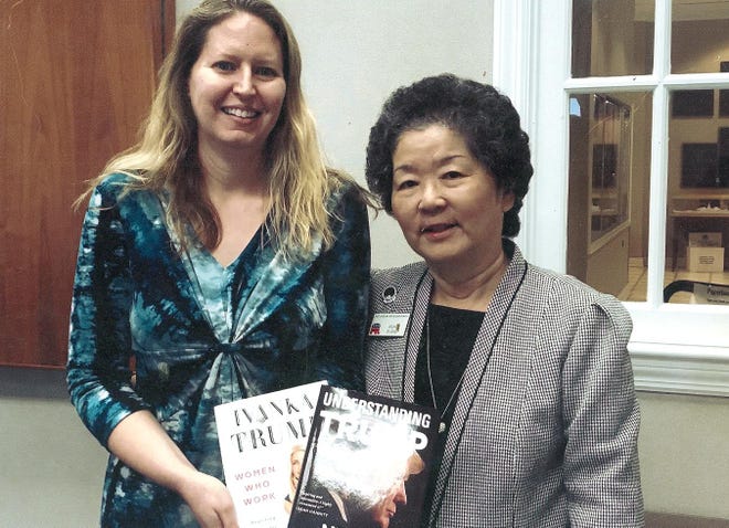 On behalf of East Carolina Republican Women, Rieko Evans, chair of the Mamie Eisenhower Library Project, presents two books, 'Women Who Work and Rewriting the Rules of Success' by Ivanka Trump and 'Understanding Trump' by Newt Gingrich to Librarian Cassandra Honeysucker at the New Bern Library. [CONTRIBUTED PHOTO]