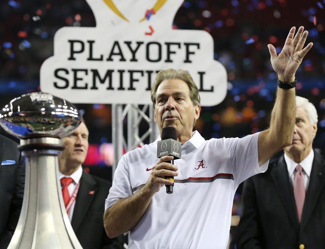 Alabama head coach Nick Saban is presented the trophy after a 24-7 victory against Washington in the Peach Bowl at the Georgia Dome in Atlanta on Saturday, Dec. 31, 2016. A new political ad is urging Alabama Republicans to write in Saban in this week's special Senate election. [Curtis Compton/Atlanta Journal-Constitution/TNS]