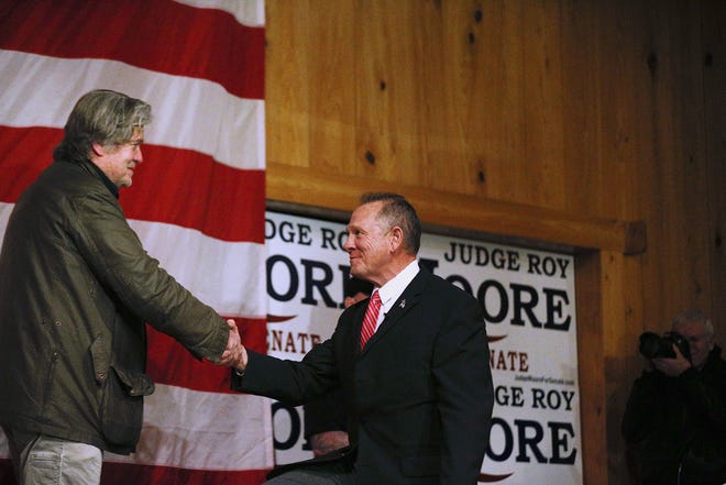Steve Bannon, left, introduces U.S. senatorial candidate Roy Moore, right, during a campaign rally, in Fairhope on Tuesday, Dec. 5, 2017. Dogged by allegations of sexual misconduct, Moore has kept to events with limited publicity and shunned contact with the traditional media in the heated race for U.S. Senate. [AP Photo/Brynn Anderson, File]