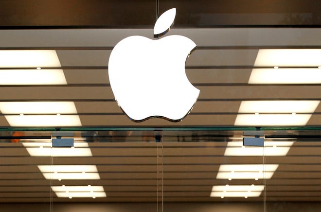 FILE - This Thursday, Sept. 19, 2013, file photo shows the Apple logo above a store location entrance in Dallas. Apple has bought Shazam, the maker of a song-recognition app that Apple's digital assistant Siri has already been using to help people identify the music playing on their iPhones. (AP Photo/Tony Gutierrez, File)