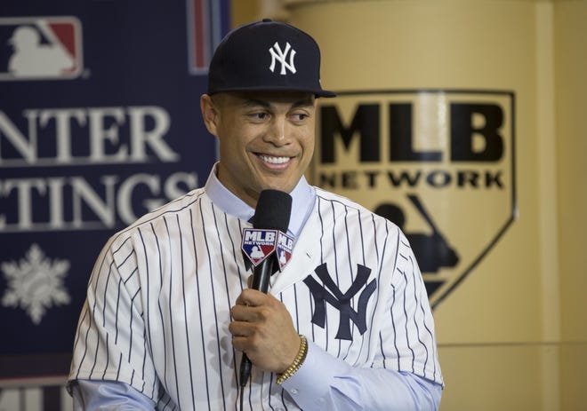 The newest member of the New York Yankees, Giancarlo Stanton, answers questions during a press conference at the Major League Baseball winter meetings in Orlando Monday. [Willie J. Allen Jr./The Associated Press]