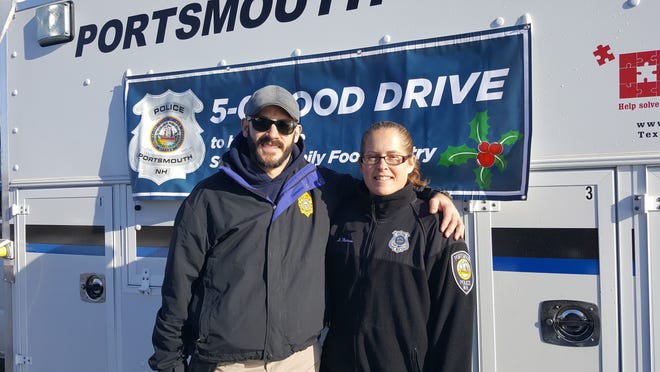 Detective Seth Tondreault and Officer Lynn Thomas head up the 5-0 Food Drive Portsmouth Police held in front on the Woodbury Avenue Market Basket on Sunday. [Karen Dandurant photo]