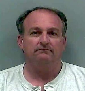Theodore L. "Ted" Martin, 54, with a last known address in Ravenna Township, shown here in a Delaware County Sheriff's Office booking photo.