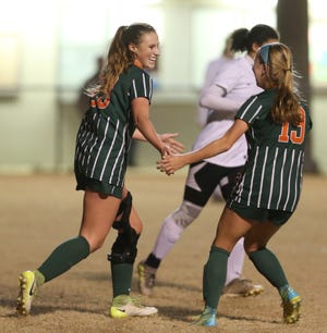 Mosley's Madi Flammia (23) celebrates scoring a goal with Abbi Legg (19) during the first half of Monday's game against North Bay Haven at Harders Park. [PATTI BLAKE/THE NEWS HERALD]