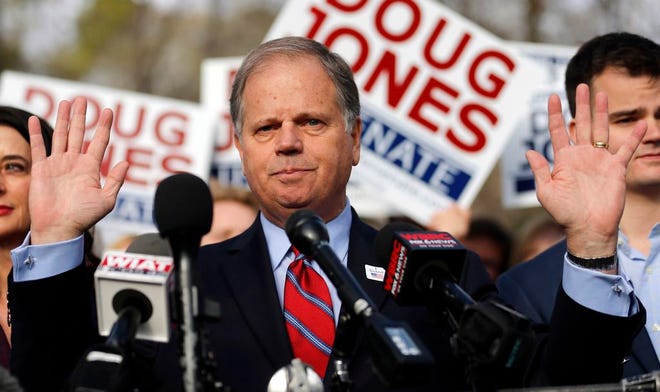In this Tuesday, Dec. 12, 2017, photo, Democratic candidate for U.S. Senate Doug Jones speaks to reporters after voting in Mountain Brook, Ala. Jones won election to the U.S. Senate from Alabama, as voters in the deeply conservative and heavily Republican state deal a stark political blow to President Donald Trump and narrow the GOPâ€™s majority in the Senate to two.