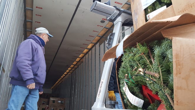 Wayne McIntire stands in a tractor trailer truck that arrived in York Monday with more than 300 Wreaths Across America wreaths for the First Parish Cemetery. [Deborah McDermott/Seacoastonline]