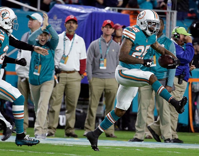 Dolphins cornerback Xavien Howard celebrates after intercepting a Tom Brady pass in the first half of Monday night's game. Howard had two picks in the game and they were turned into 10 points.