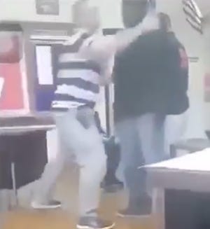 A screenshot taken from a video that shows a McKinley High School teacher slamming a student to the ground. The teacher has been placed on paid administrative leave pending the district's investigation. What led up to the incident is unclear.
