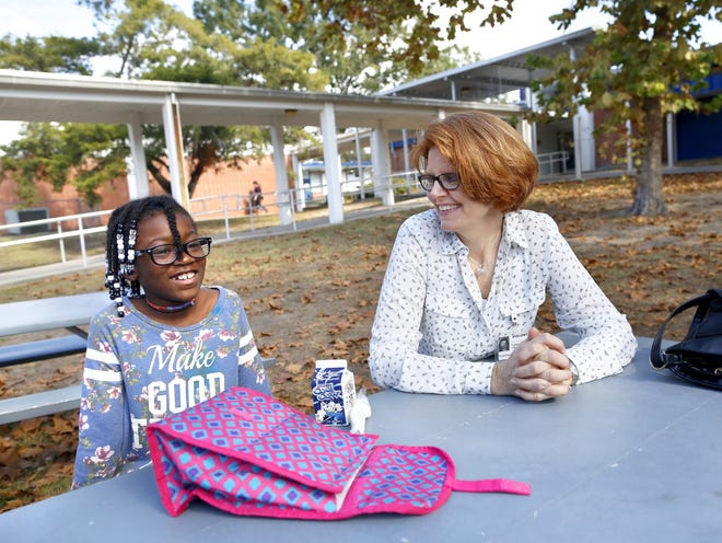 Kalese Seamore, 9, a third grader at Terwilliger Elementary, jokes with her "lunch buddy" Laura Clark, a volunteer in the Alachua County Public Schools program Lunch Buddies, during lunch at the school. The mentoring program for elementary school students, Lunch Buddies, asks volunteers once a week to visit with their student and talk about their lives, the day or whatever comes up. [Brad McClenny/The Gainesville Sun]