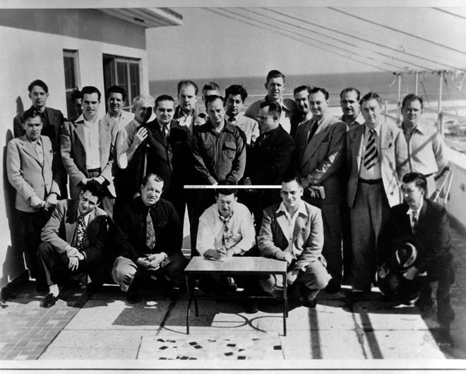 Many of those from the racing community who gathered at the Streamline in 1947, pose for a group photo on the Streamline roof. "Big Bill" France is the tall one, near the middle of the back row. [PHOTO PROVIDED]
