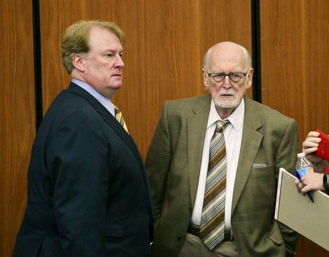 FILE - In a May 23, 2017 file photo, former Majority Leader Rick Quinn, left, and his father, Richard Quinn Sr. pause as they talk during a break in a hearing to get solicitor David Pascoe disqualified from the prosecution of Quinn in Columbia, S.C. Solicitor David Pascoe announced Wednesday, Oct. 18, that the State Grand Jury had returned indictments against Richard Quinn on charges of criminal conspiracy and failure to register as a lobbyist. Grand jurors also issued new indictments for two lawmakers already charged. Rep. Rick Quinn, the elder Quinnâ€™s son, was charged with criminal conspiracy. (Tim Dominick/The State via AP)