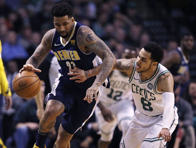 Celtics guard Shane Larkin defends the Nuggets' Wilson Chandler during the second half Wednesday. Larkin scored 14 points off the bench on 6-of-6 shooting and sparked Boston's defense in the fourth quarter. [Charles Krupa/AP]