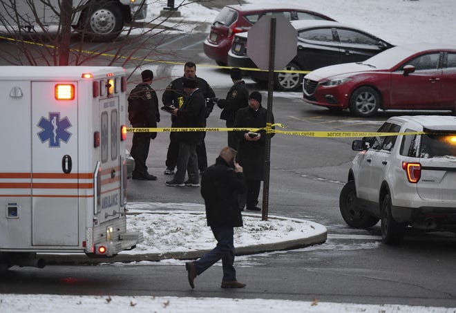 Authorities investigate the scene of a shooting at the Penn State University campus in Beaver County in Monaca, Pa., Wednesday, Dec. 13, 2017. Police say a woman who worked at a Penn State satellite campus was apparently shot dead in the university parking lot by her estranged husband and the man then killed himself. (Kevin Lorenzi/Beaver County Times via AP)