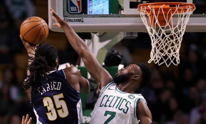 Celtics guard Jaylen Brown tries to block a shot by Nuggets forward Kenneth Faried during the first quarter of Wednesday's game in Boston.