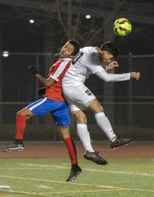 East Union's Alex Velasquez, left, and West's Elias Belloso fight for a header during a boys varsity soccer game at West High in Tracy. [CLIFFORD OTO/THE RECORD]
