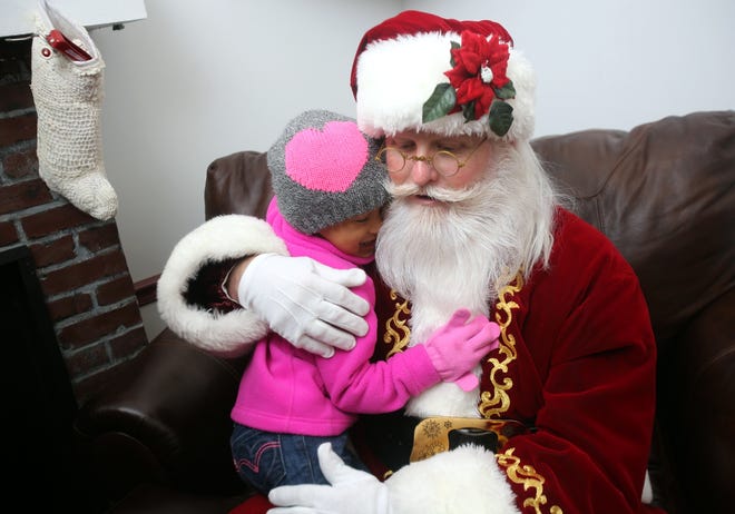 Jayda Haynes hugs Santa on a visit to uptown Shelby in 2015. The Star will welcome its own Santa on Monday night. [Brittany Randolph/The Star]