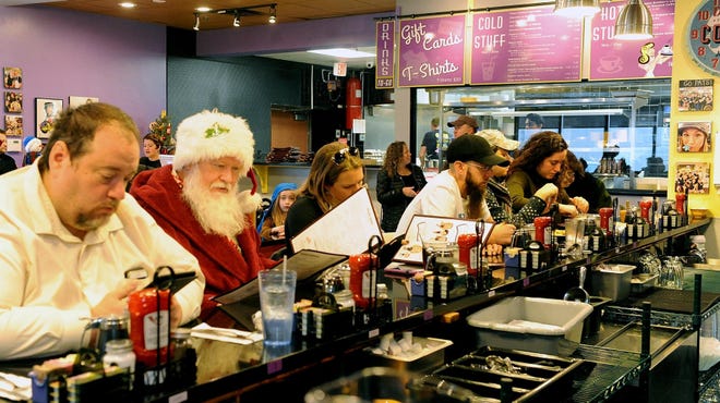 Patrons at the counter, including Bob Jordon of Framingham, dressed as Santa, on the opening day of the new J & M Diner at 50 Worcester Road. The original diner was one of nine stores destroyed by fire in 2017 in the Old Path Village shopping plaza on Concord Street. [Daily News and Wicked local Staff Photo/Art Illman]