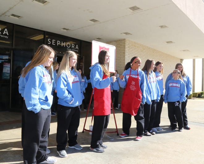 Members of the Southside High School softball team spend time Tuesday, Dec. 12, 2017, ringing the bells for the Salvation Army in front of the Rogers Avenue entrance of J.C. Penney as a way to give back to the community during the holiday season. [JAMIE MITCHELL/TIMES RECORD]