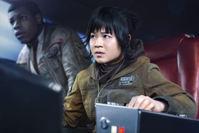 This image released by Lucasfilm shows Kelly Marie Tran as Rose and John Boyega as Finn, left, in "Star Wars: The Last Jedi." (Jonathan Olley/Lucasfilm via AP)