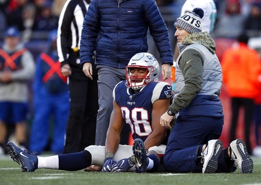 Patriots defensive end Trey Flowers, shown getting attention on the field after an injury in game against the Dolphins on Nov. 26, hopes to play against Steelers in game at Pittsburgh on Sunday. [AP Photo/Michael Dwyer]