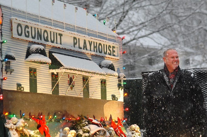 Ogunquit Playhouse Managing Director Kent Bridges rides on a float with a miniature playhouse during Saturday's Christmas by the Sea parade in Ogunquit.

[Ralph Morang/Seacoastonline]
