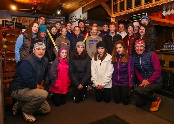 Coach Dana Babyak, front right, and assistant coach Richard Luff, front left, pose with the Winnacunnet High School nordic ski team after Wednesday's practice at Sagamore-Hampton Golf Club. [Matt Parker photo/Seacoastonline]
