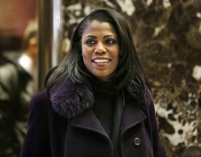 FILE - In this Dec. 13, 2016 file photo, Omarosa Manigault smiles at reporters as she walks through the lobby of Trump Tower in New York. The White House says Omarosa Manigault Newman, one of President Donald TrumpþÄôs most prominent African-American supporters, plans to leave the administration next month.  (AP Photo/Seth Wenig)