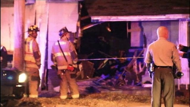 Officials investigate after car runs through home on Ozark Avenue and Ida Street late Thursday.

[WSOC]