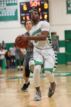 Ja'Quail Brown of Ashbrook drives to the rim during the Green Wave's win over Forestview on Friday, Dec. 15. [BILL BOSTICK/SPECIAL TO THE GAZETTE]