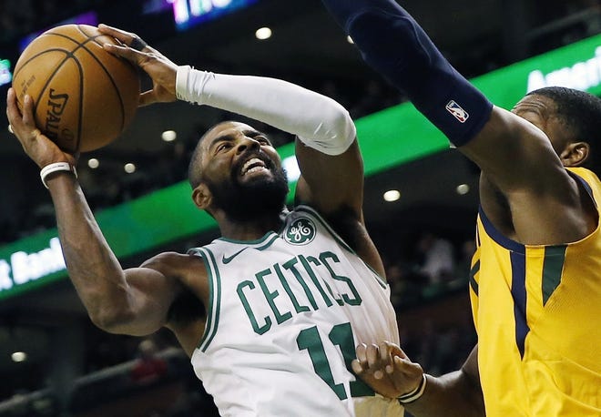 Celtics guard Kyrie Irving (left) tries to get to the basket against the defense of Utah's Joe Johnson during Boston's 107-95 loss on Friday night.